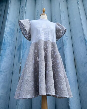 Reworked  sports T-shirt  into a cute  skater dress in laser cut design skirt and short flared sleeve a pale dove grey.
